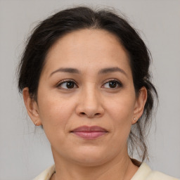 Joyful white adult female with medium  brown hair and brown eyes