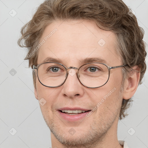 Joyful white adult male with short  brown hair and blue eyes