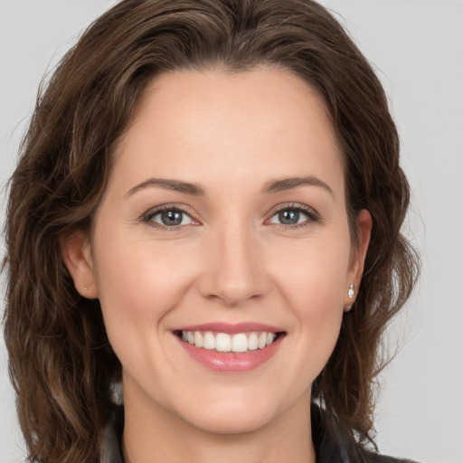 Joyful white young-adult female with long  brown hair and grey eyes