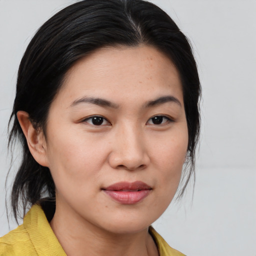 Joyful asian young-adult female with medium  black hair and brown eyes