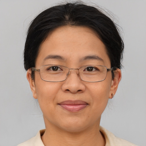 Joyful asian adult female with short  brown hair and brown eyes