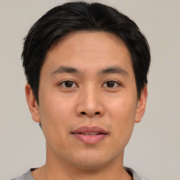 Joyful asian young-adult male with short  brown hair and brown eyes