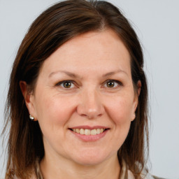 Joyful white adult female with medium  brown hair and brown eyes