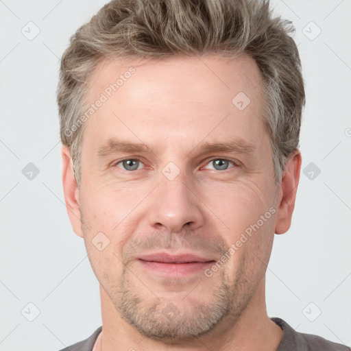 Joyful white adult male with short  brown hair and grey eyes