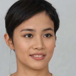 Joyful asian young-adult female with short  brown hair and brown eyes