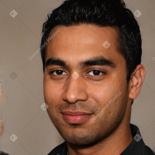 Joyful latino young-adult male with short  black hair and brown eyes