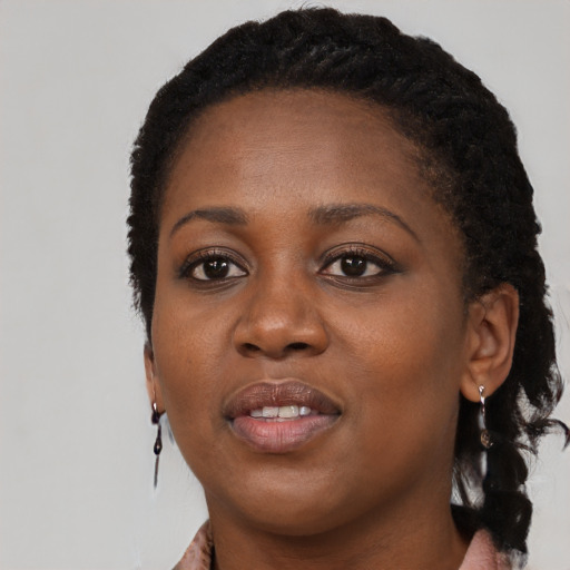 Joyful black young-adult female with long  black hair and brown eyes