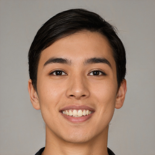 Joyful latino young-adult male with short  black hair and brown eyes