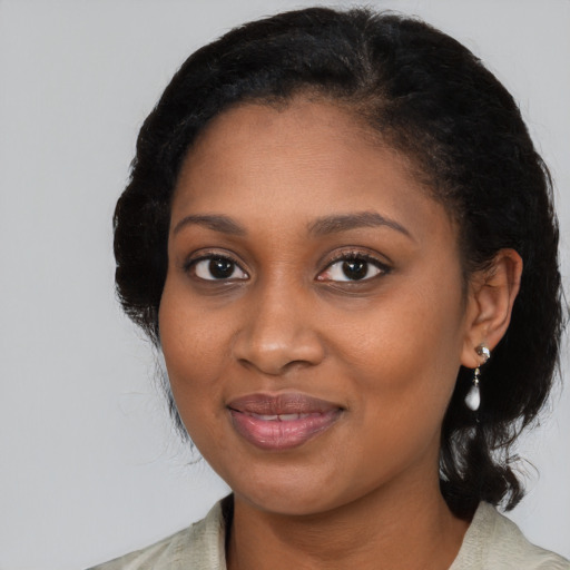 Joyful black young-adult female with medium  brown hair and brown eyes