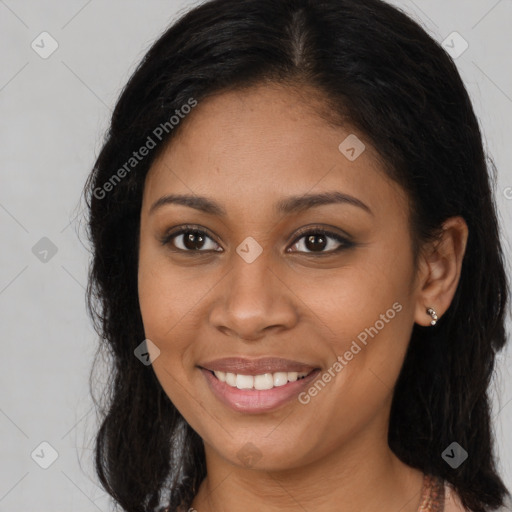 Joyful black young-adult female with long  brown hair and brown eyes