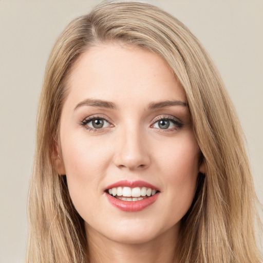 Joyful white young-adult female with long  brown hair and green eyes