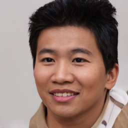 Joyful asian young-adult male with short  black hair and brown eyes