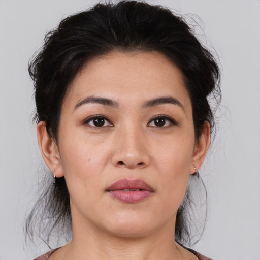 Joyful asian young-adult female with medium  black hair and brown eyes