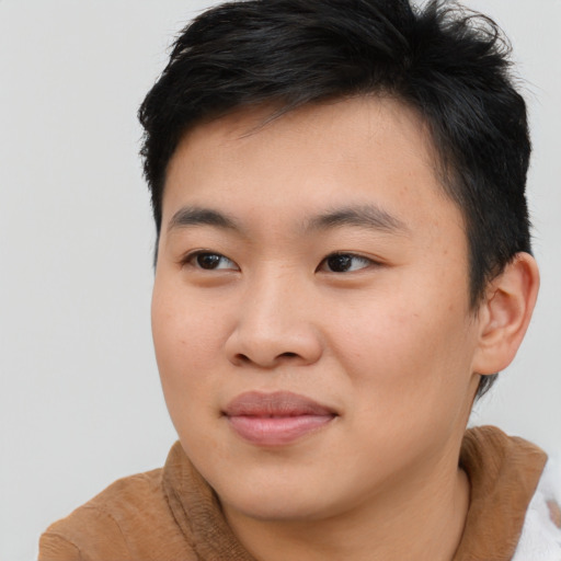 Joyful asian young-adult male with short  brown hair and brown eyes