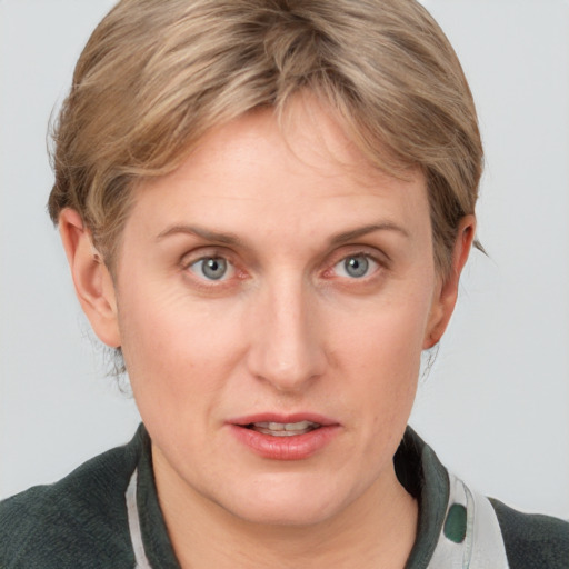 Joyful white young-adult female with medium  brown hair and blue eyes