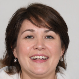 Joyful white adult female with medium  brown hair and brown eyes