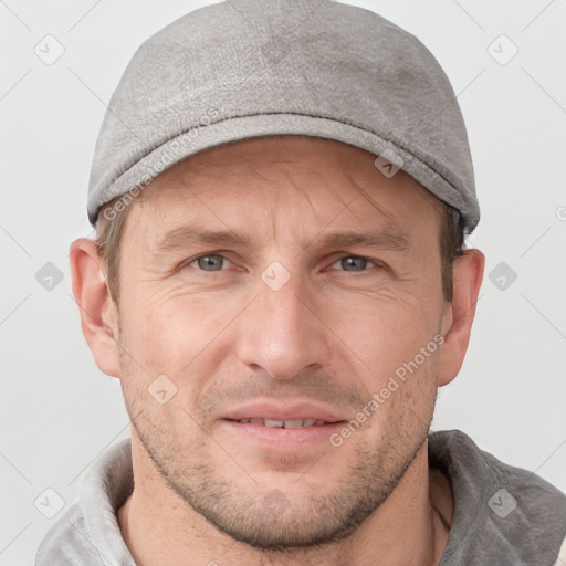 Joyful white adult male with short  brown hair and grey eyes