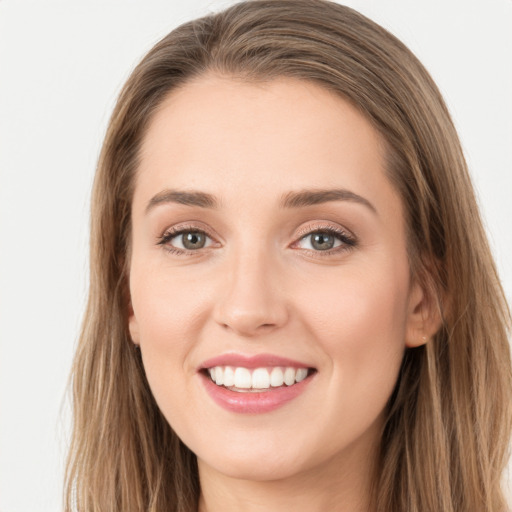 Joyful white young-adult female with long  brown hair and grey eyes