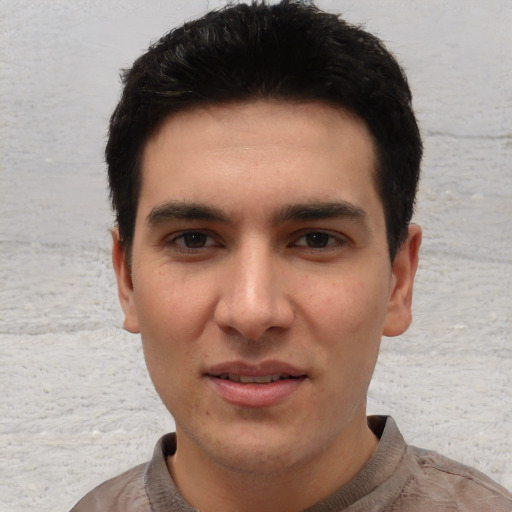 Joyful white young-adult male with short  black hair and brown eyes