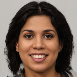 Joyful latino young-adult female with long  brown hair and brown eyes