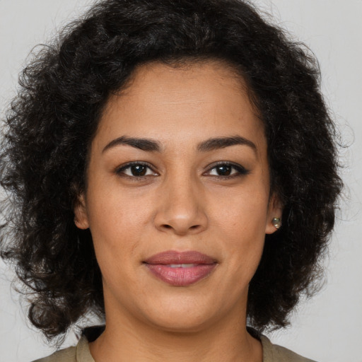 Joyful latino young-adult female with medium  brown hair and brown eyes