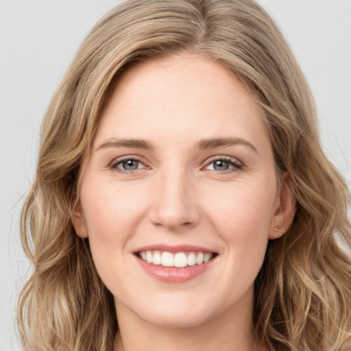 Joyful white young-adult female with long  brown hair and green eyes