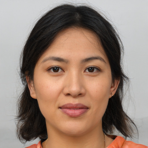 Joyful asian young-adult female with medium  brown hair and brown eyes