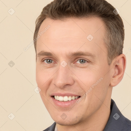 Joyful white young-adult male with short  brown hair and brown eyes