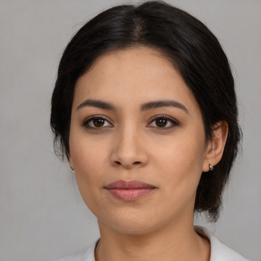 Joyful latino young-adult female with medium  black hair and brown eyes