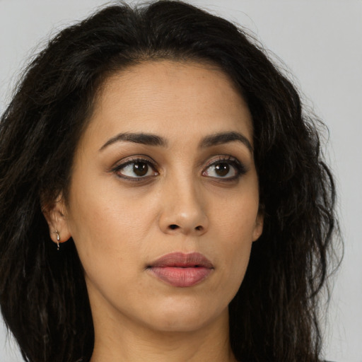 Neutral latino young-adult female with long  brown hair and brown eyes