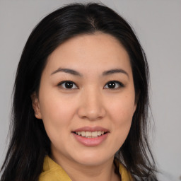 Joyful asian young-adult female with medium  brown hair and brown eyes