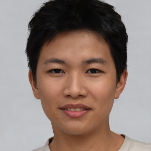 Joyful asian young-adult male with short  black hair and brown eyes