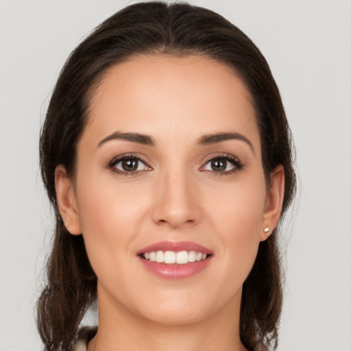 Joyful white young-adult female with medium  brown hair and brown eyes