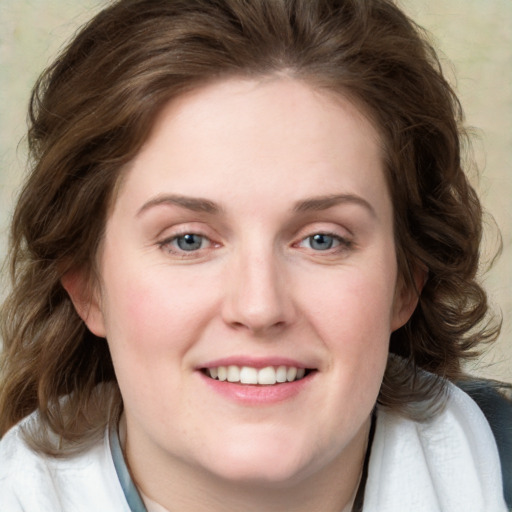 Joyful white young-adult female with medium  brown hair and blue eyes