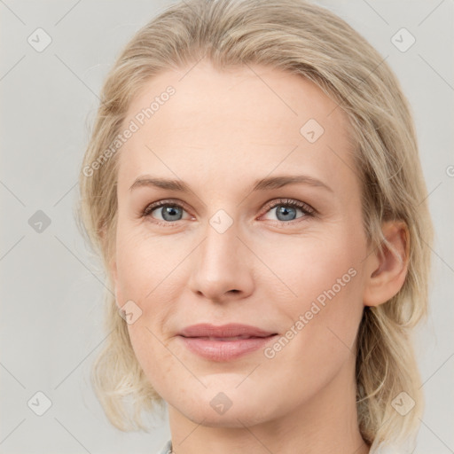 Joyful white young-adult female with medium  brown hair and blue eyes