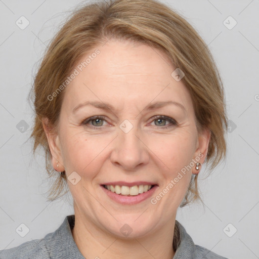 Joyful white adult female with medium  brown hair and grey eyes