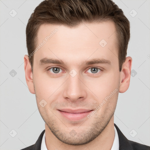 Joyful white young-adult male with short  brown hair and grey eyes