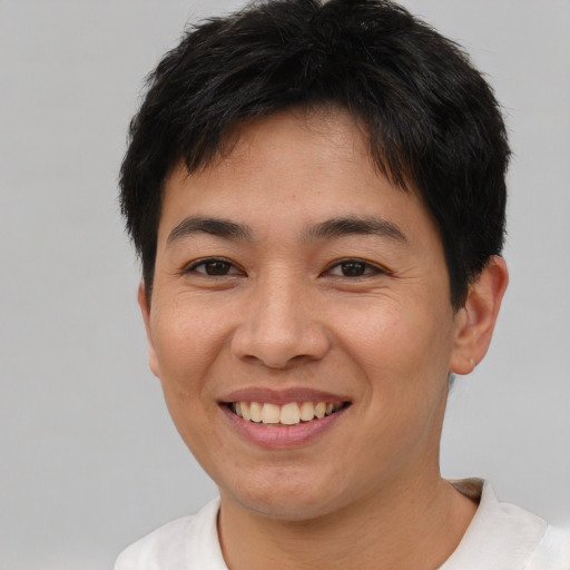 Joyful asian young-adult male with short  brown hair and brown eyes
