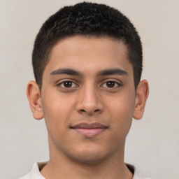 Joyful latino young-adult male with short  brown hair and brown eyes