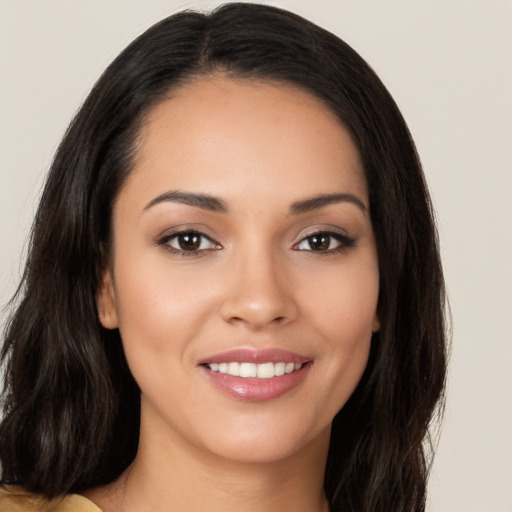 Joyful latino young-adult female with long  brown hair and brown eyes