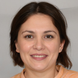 Joyful white adult female with medium  brown hair and brown eyes