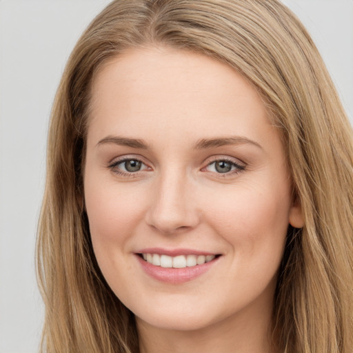 Joyful white young-adult female with long  brown hair and grey eyes