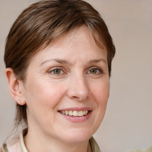 Joyful white adult female with medium  brown hair and grey eyes