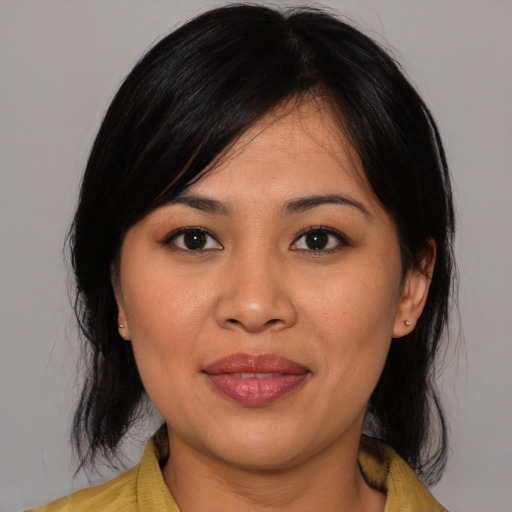 Joyful asian young-adult female with medium  black hair and brown eyes