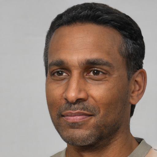 Neutral latino adult male with short  black hair and brown eyes