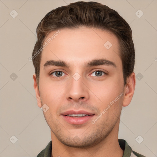 Joyful white young-adult male with short  brown hair and grey eyes