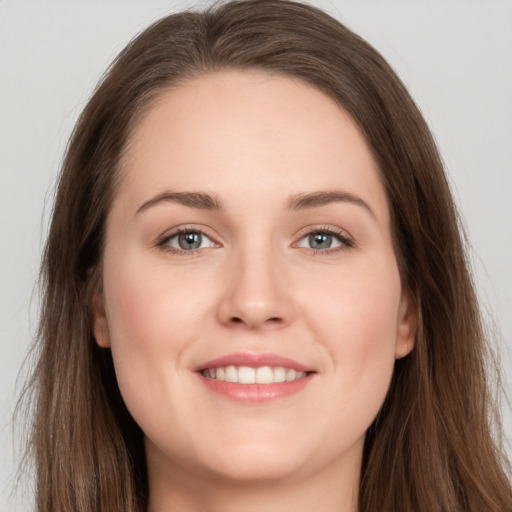 Joyful white young-adult female with long  brown hair and grey eyes