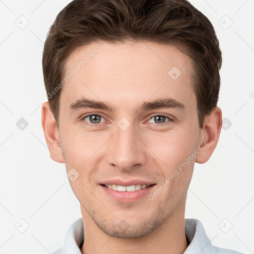 Joyful white young-adult male with short  brown hair and grey eyes