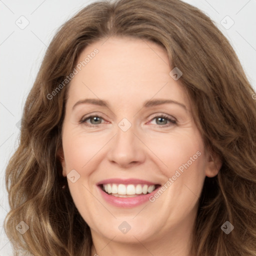 Joyful white adult female with long  brown hair and brown eyes