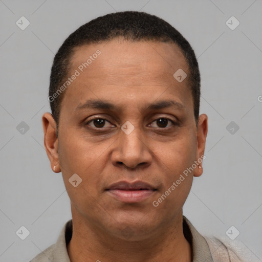 Joyful latino adult male with short  brown hair and brown eyes